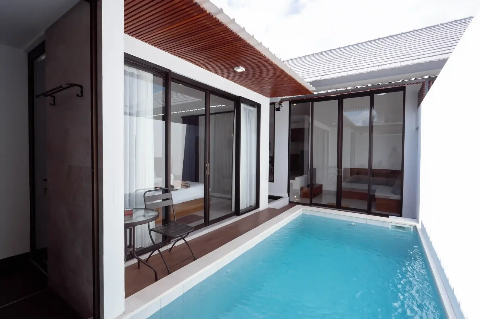 Seminyak villa with a lap pool running alongside a covered outdoor living room