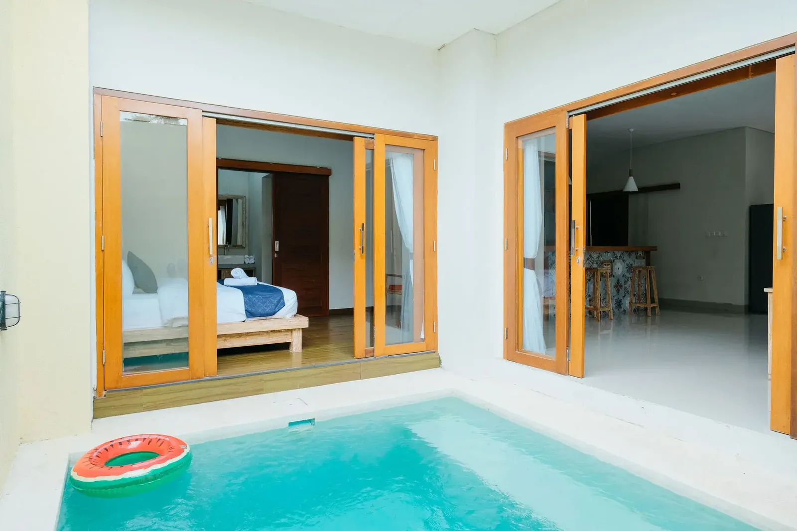 Villa pool with folding glass doors opening directly from the bedroom